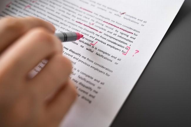 Một người đang sắp xếp các tài liệu học thuật với từ "With Respect To" nổi bật trên giấy